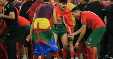 Morocco's reserve goalkeeper Munir Mohamedi can be seen with Amazigh flag around his waist as the Moroccan team celebrate their win against Spain on 6 December 2022